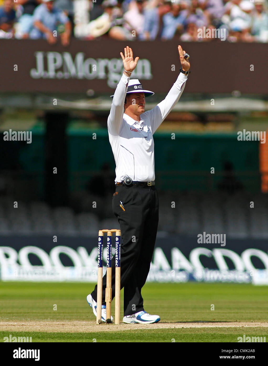 Cricket umpire signaling Six runs Stock Photo - Alamy