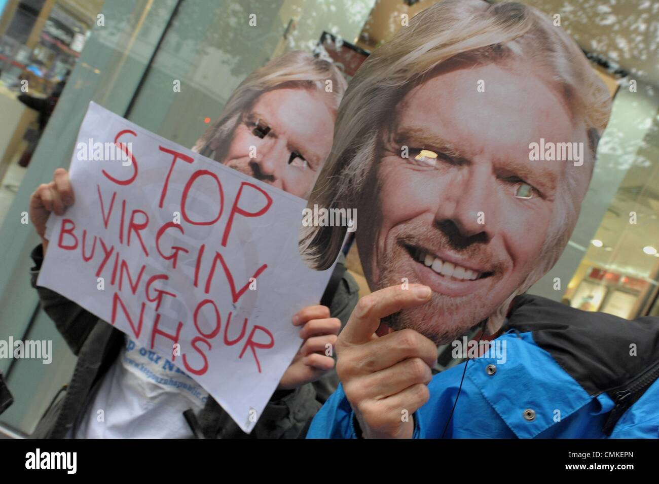 London, UK, UK. 3rd Nov, 2013. A flash mob protests outside the Virgin Mobile store in Brixton London. The group called 'Keep Our NHS Public' hopes to continue to bring attention to Virgin's plans to privatise the National Heath Service © Gail Orenstein/ZUMAPRESS.com/Alamy Live News Stock Photo