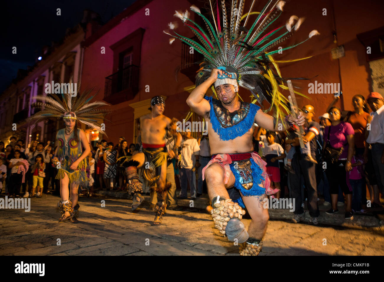 Revelers dressed as Mayan Indians parade through the streets dressed in costumes during the Day of the Dead Festival known in spanish as D’a de Muertos on November 1, 2013 in Oaxaca, Mexico. Stock Photo