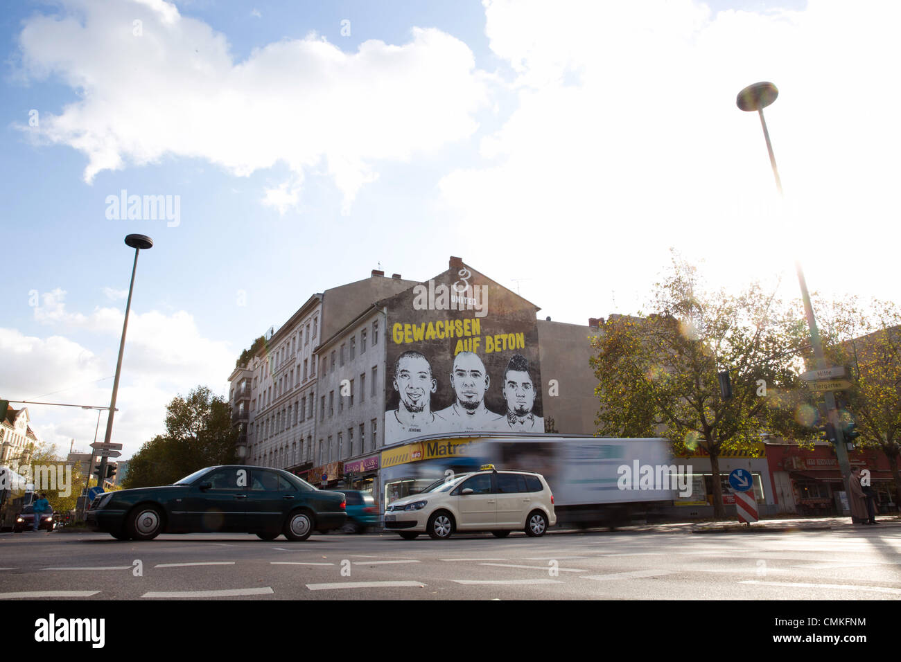Berlin-Wedding, Germany. 30th Oct, 2013. A sporting good manufacturer advertises with the faces of the brothers Jerome (L-R), George and Kevin-Prince Boateng on the wall of a building in Berlin-Wedding, Germany, 30 October 2013. Schalke's pro soccer player Kevin-Prince Boateng supposedly learned how to play soccer in this cage. Photo: Joerg Carstensen/dpa/Alamy Live News Stock Photo