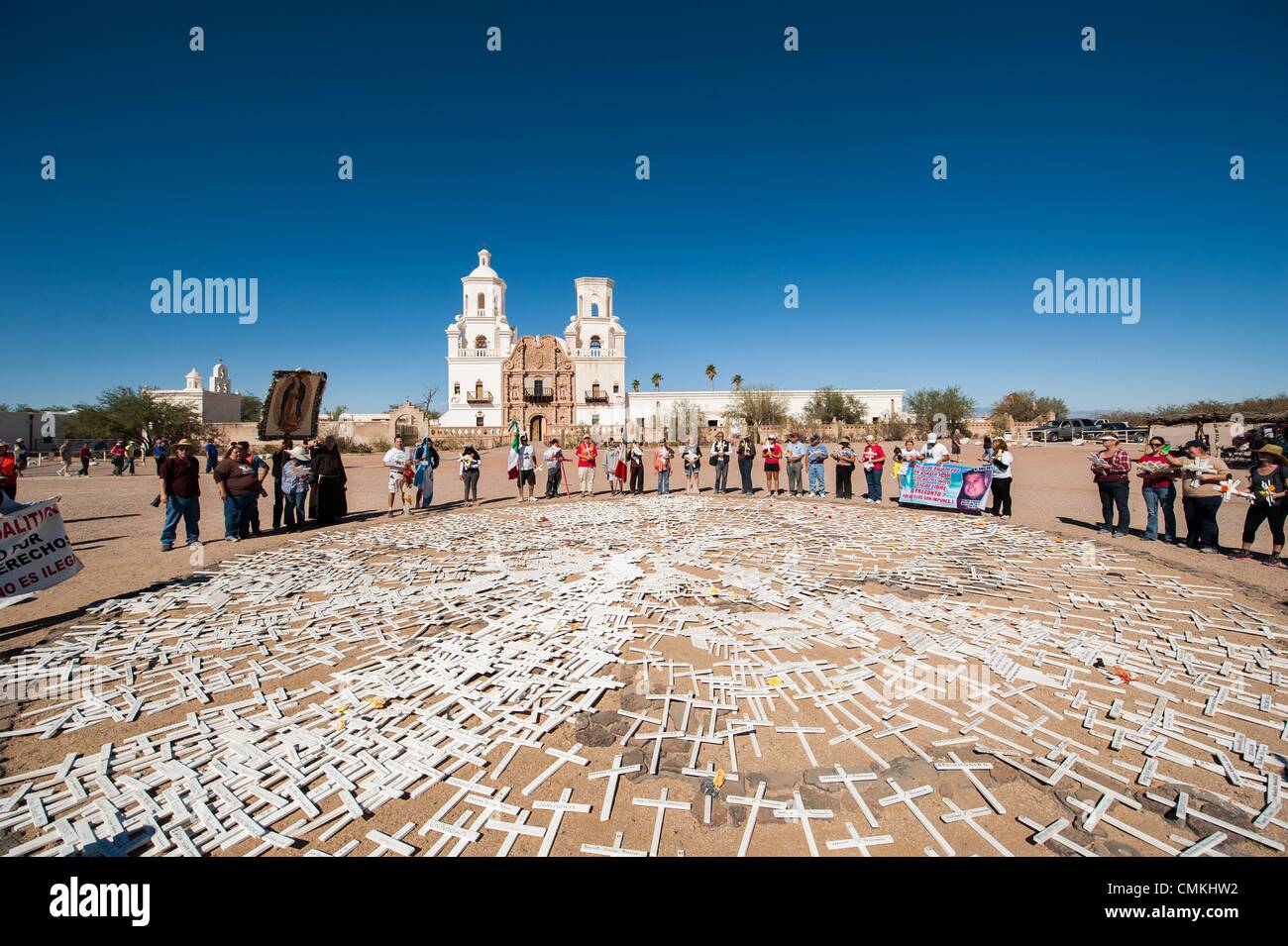 Tucson, Arizona, USA. 2nd Nov, 2013. More than 100 people walked eight miles from Tucson, Ariz. to Mission San Xavier del Bac, a Spanish colonial mission, in an El Dia de los Muertos procession remembering people who died crossing the Arizona desert between Mexico and the U.S. According to the human rights group Derechos Humanos, 129 bodies have been found in Tucson Sector between Oct. 2012 and June 2013. More than 2,500 bodies have been found in the desert since 2000; many of whom are unidentified. Each of the white crosses represents one dead migrant. Stock Photo