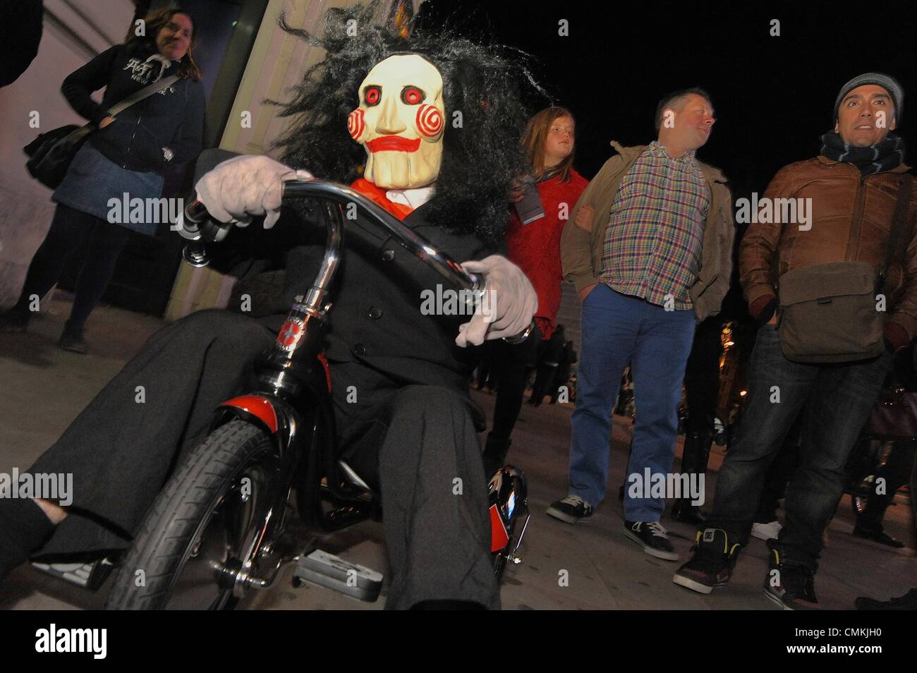 London, UK, UK. 3rd Nov, 2013. A performer rides a tricycle wearing a clown mask in front of The famous Piccadilly Institute which hosted it's annual Halloween costume ball Credit: Gail Orenstein/ZUMAPRESS.com/Alamy Live News Stock Photo