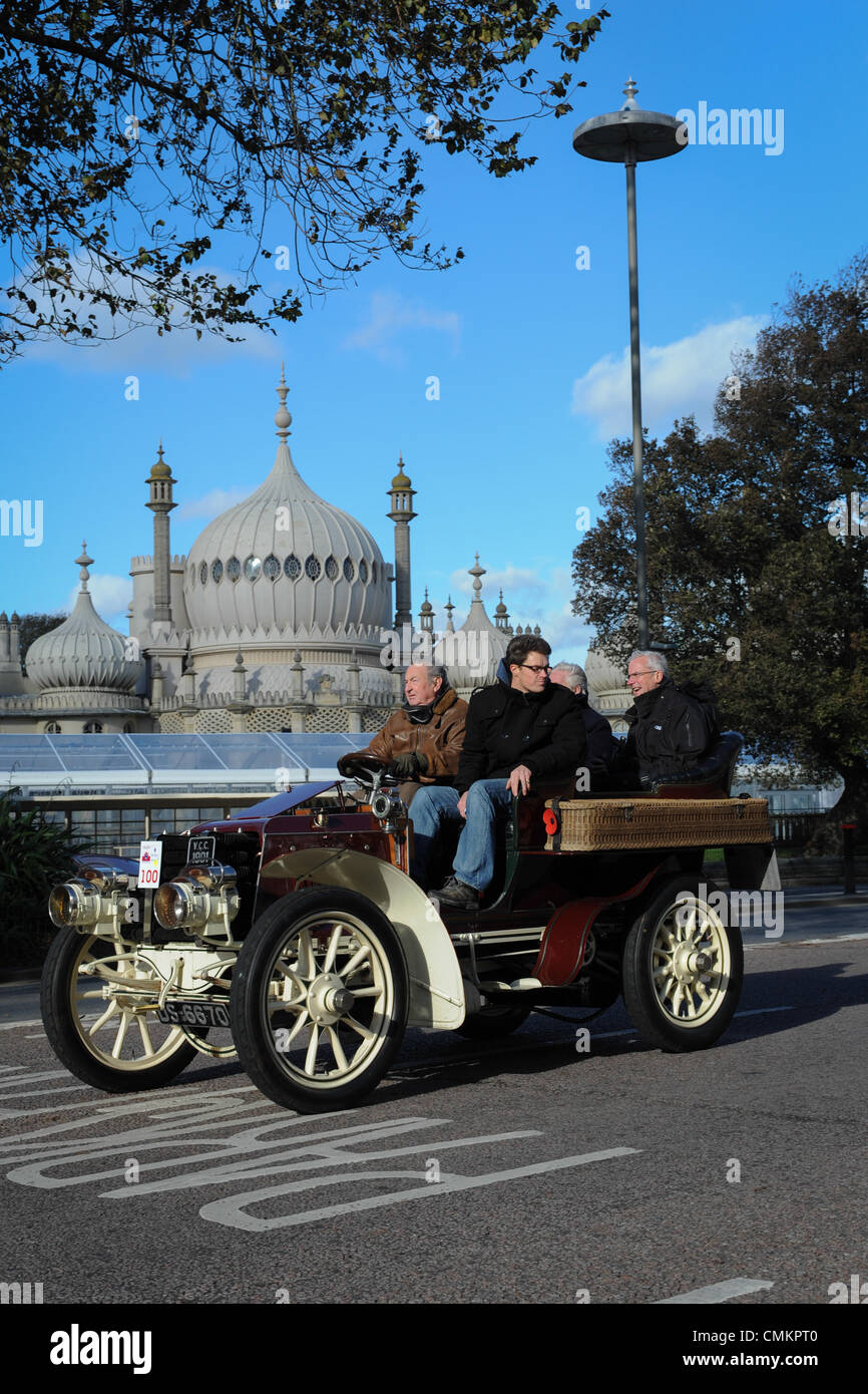 Competitors driving an old veteran car drive past the Royal Pavilion as