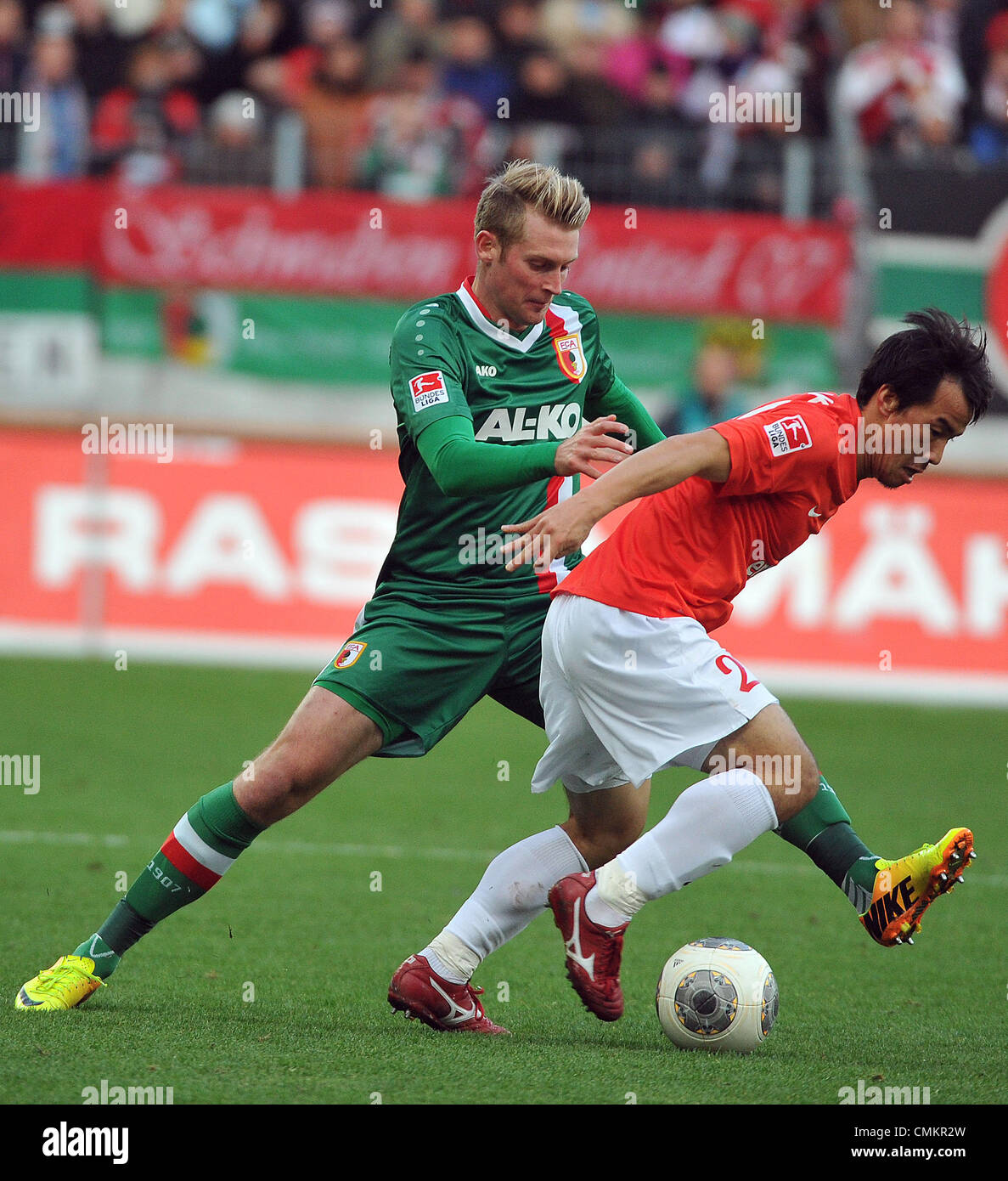 Augsburg, Germany. 03rd Nov, 2013. Augsburg's Jan-Ingwer Callsen-Bracker (L) vies for the ball with Mainz's Park Joo-Ho during the German Bundesliga match between FC Augsburg and 1.FSV Mainz 05 at the SGL-Arena in Augsburg, Germany, 03 November 2013. Photo: STEFAN PUCHNER/dpa/Alamy Live News Stock Photo