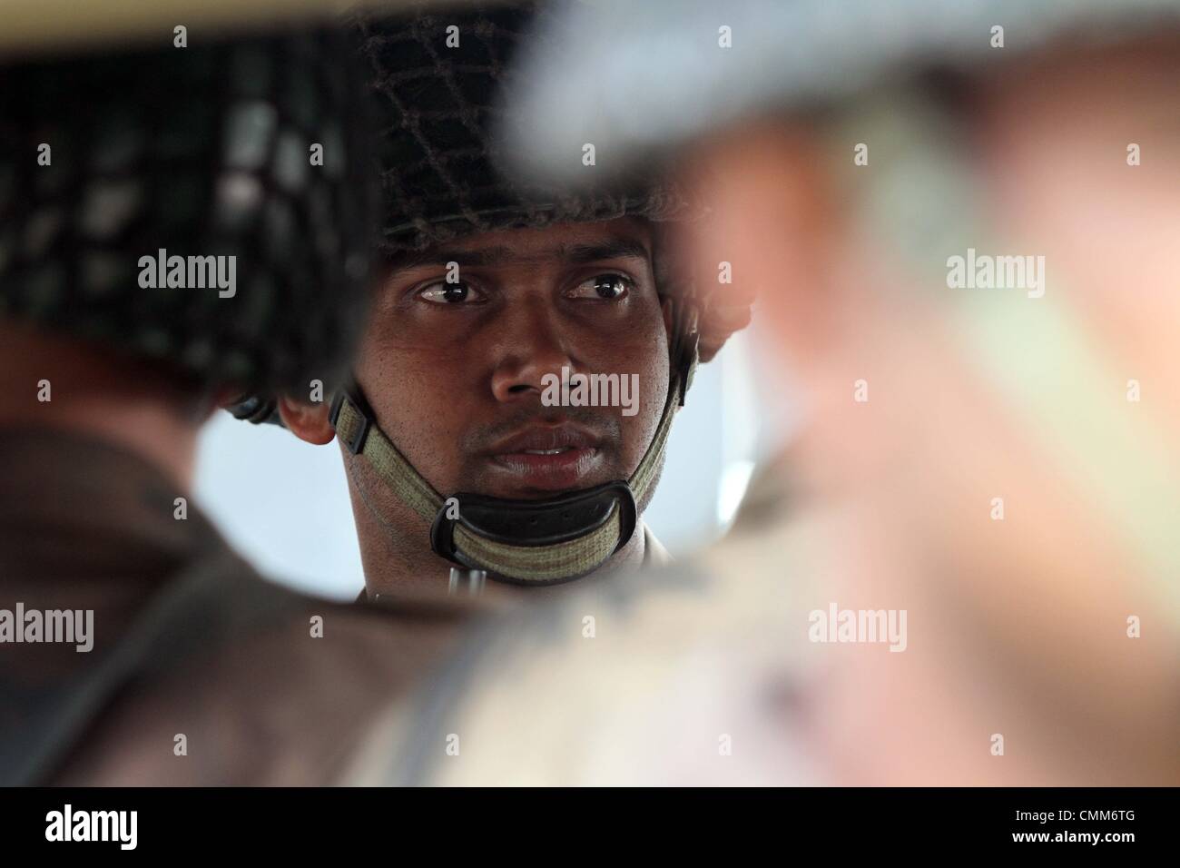 Dhaka, Bangladesh. 5th November 2013. Members of the Border Guard Bangladesh (BGB) are seen prior to the verdict at the Alia Madrasa playground, next to the Dhaka Central Jail, in Dhaka, Bangladesh, 05 November 2013. According to media reports, a total of 850 persons, including 23 civilians, have been accused for killing a total of 74 people, including 57 army officers, in the BDR mutiny on 25 February 2009. The verdict is expected on 05 November 2013. Stock Photo