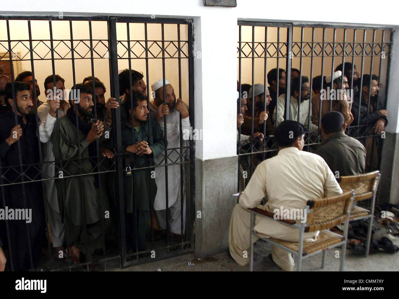 Criminals arrested during search operation are in police custody as the police officials are doing investigation at police station in Peshawar on Tuesday, November 05, 2013. Stock Photo