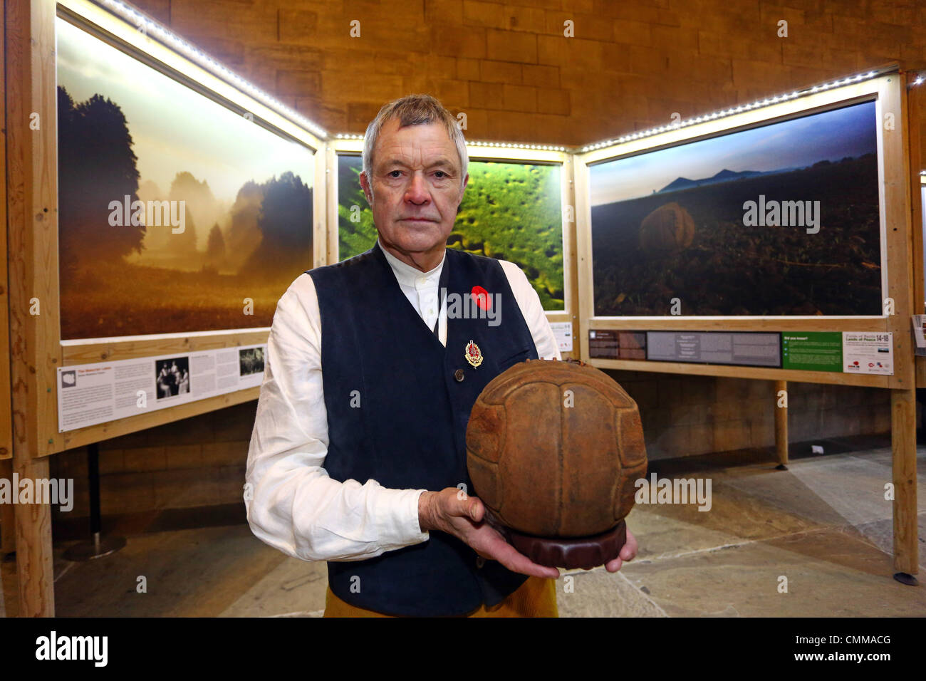 London, UK. 5th November 2013. Photographer Mike St. Maur Sheil with the Loos Football (This is the football which the London Irish Rifles kicked across No Mans Land on Sept 25th 1915 as they attacked the German positions in the town of Loos) at the Fields of Battle Lands of Peace 14-18 pre-launch exhibition at Westminster Hall, Houses of Parliament, London. Announcing a major commemorative WWI exhibition by World Press Photo Award-winning photographer Mike St. Maur Sheil which will launch in London in 2014 and tour English towns for the next four years. Credit:  Paul Brown/Alamy Live News Stock Photo