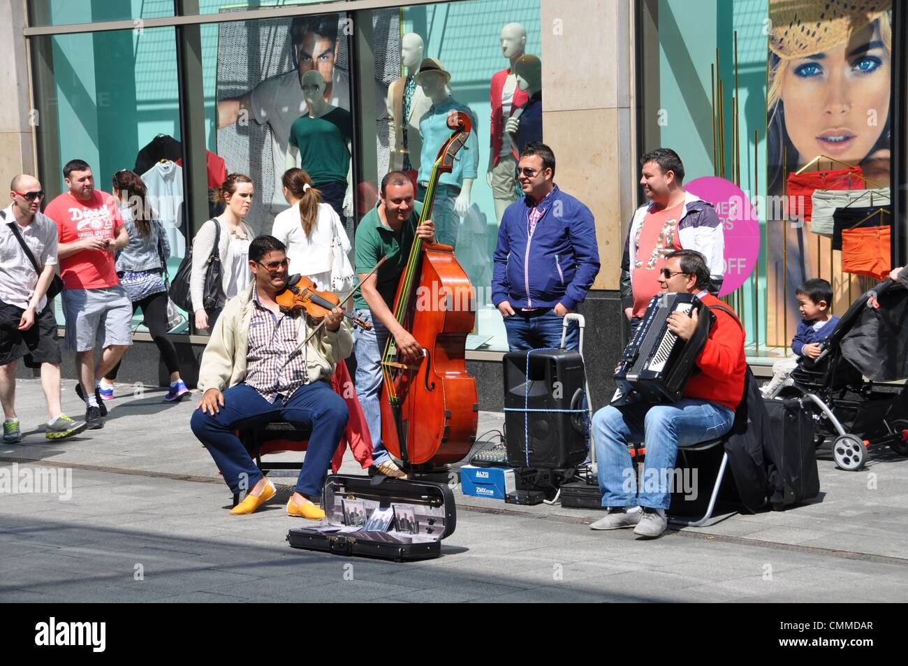 Irish music in the street: Three men play Irish folk music in Mary Street in downtown Dublin, photo taken June 4, 2013. Only few passers-by appreciate the efforts of the small band by some coins. Photo: Frank Baumgart Stock Photo