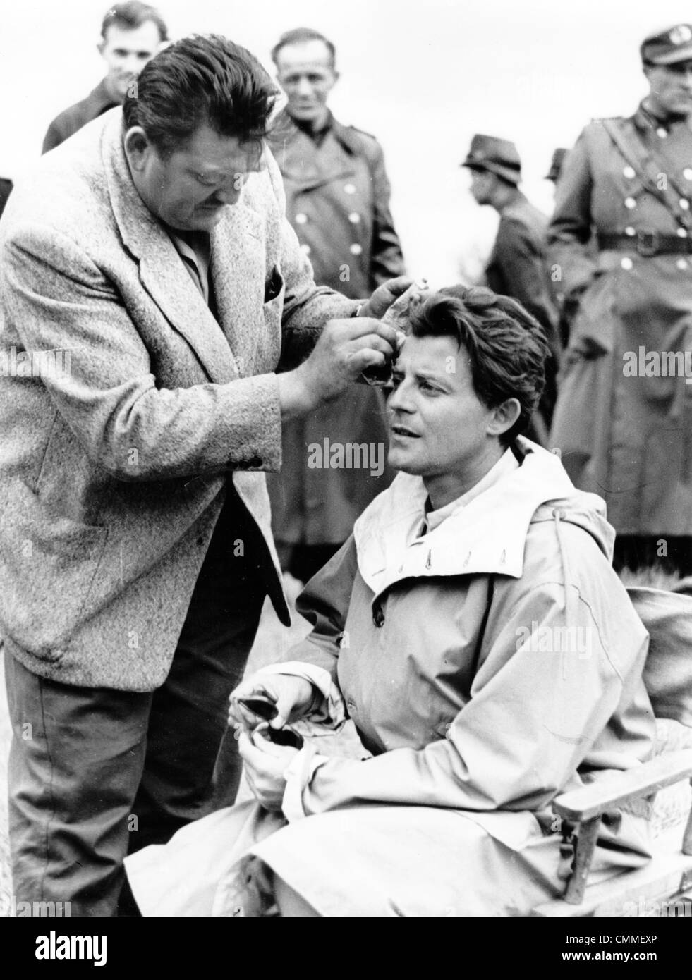 French actor Gerard Philipe is made up during the shooting of the film (literally) 'The adventures of Till Ulenspiegel' in Raguhn, GDR, 1956. In the joint East-German-French production of DEFA (East Germany) and Les Films Ariane (France), Philipe played the main characters and directed the movie which was his only directing job of his career. Photo: Hanns-Peter Beyer - ATTENTION! NO WIRE SERVICE Stock Photo