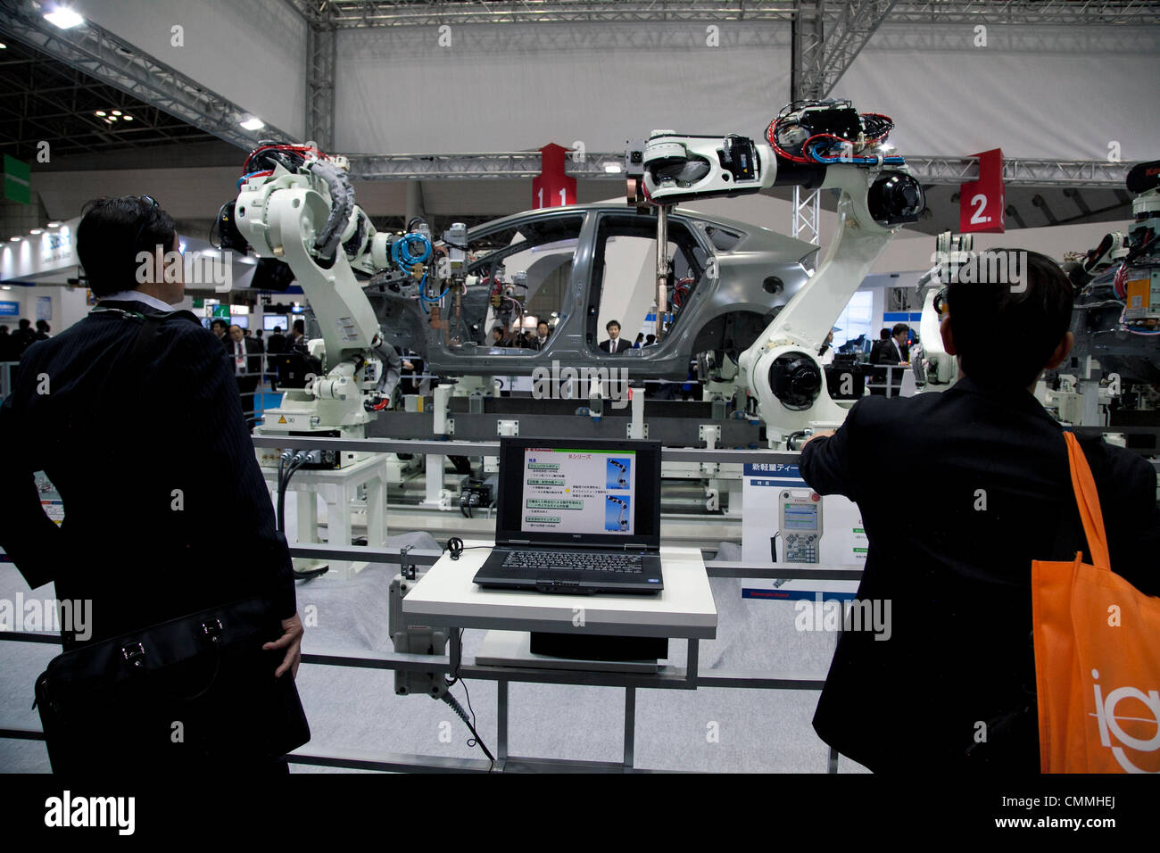 Tokyo, Japan. 6th Nov, 2013. Visitors see the Kawazaki 'Body Assembly' system performance at the International Robot Exhibition 2013 in Tokyo, Japan, November 6, 2013. The IREX is the largest robot trade fair in the world and shows new robots and high technology equipments at theTokyo International Big Sight. The exhibitions runs from November 6 to 9. © Rodrigo Reyes Marin/AFLO/Alamy Live News Stock Photo