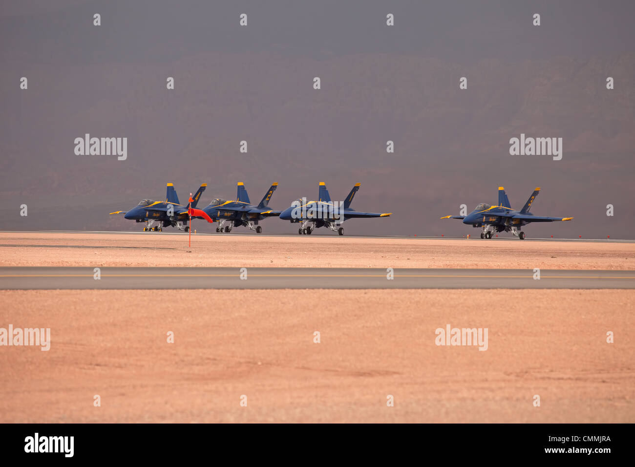 Navy Blue Angel demonstration fighter jets fly by in close formation during takeoff on runway video. Yellow and blue supersonic. Stock Photo