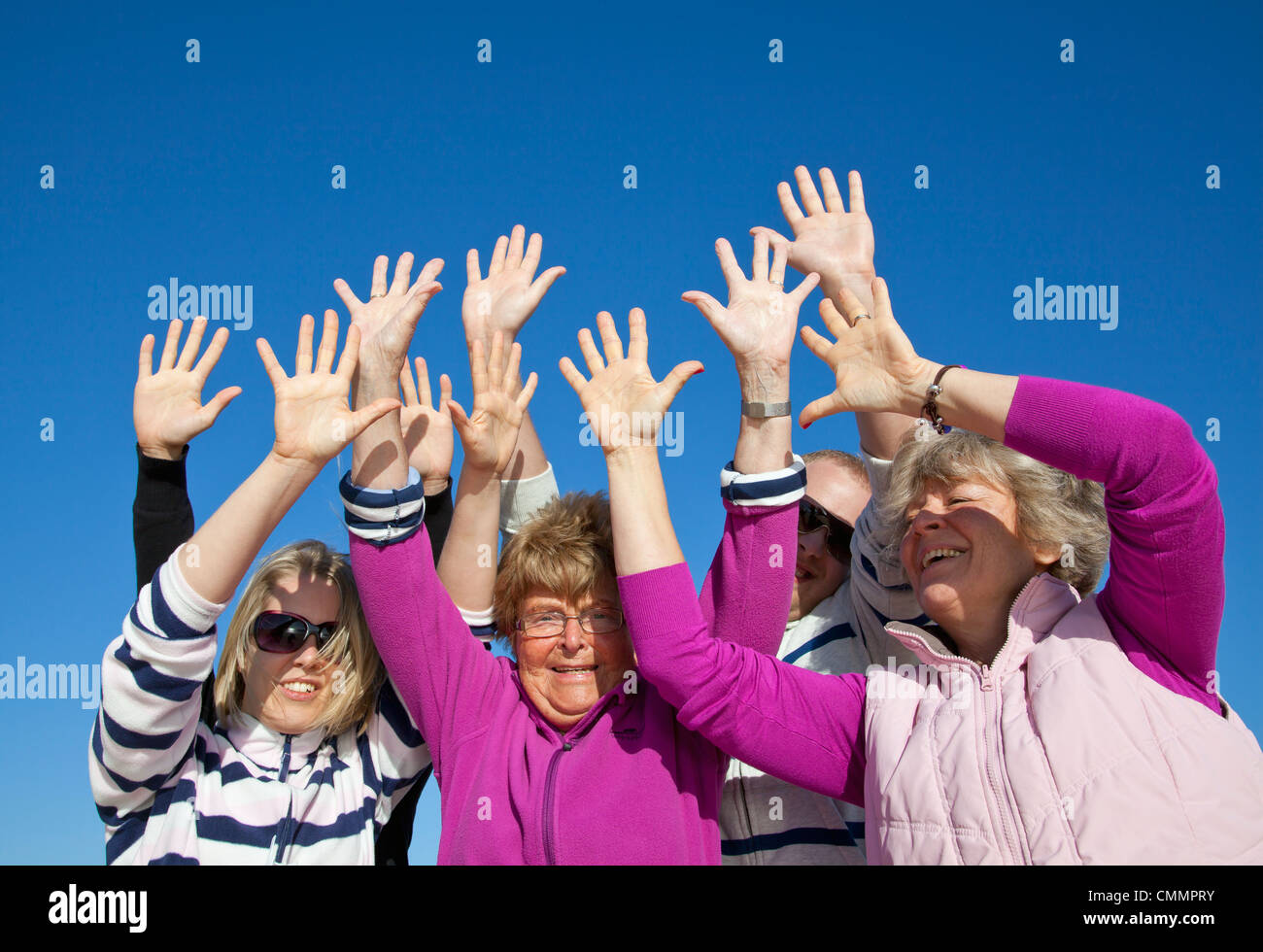 Group raise hi-res stock photography and images - Alamy