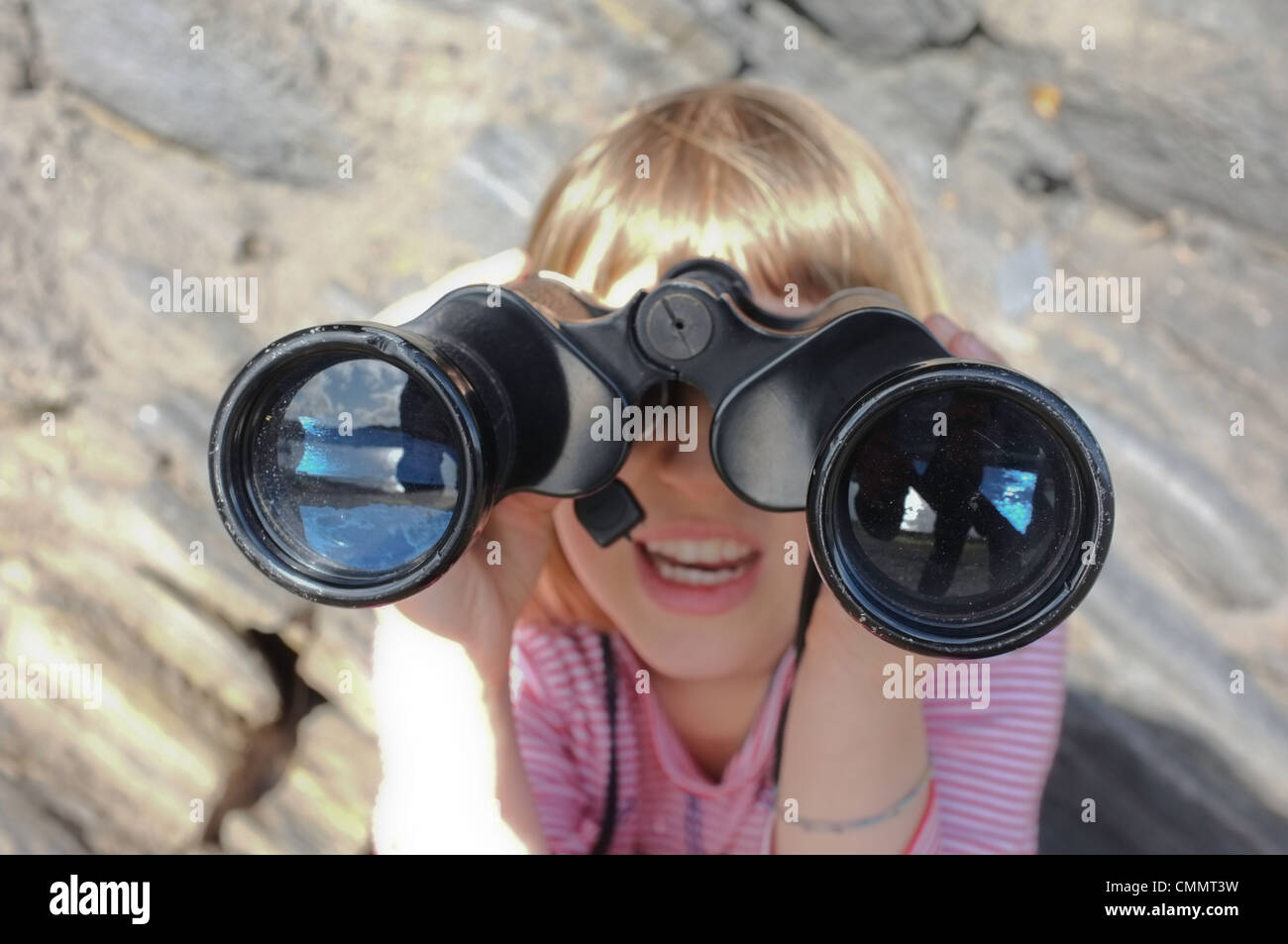 A 9 year old girl looking for birds through a pair of Binoculars Stock