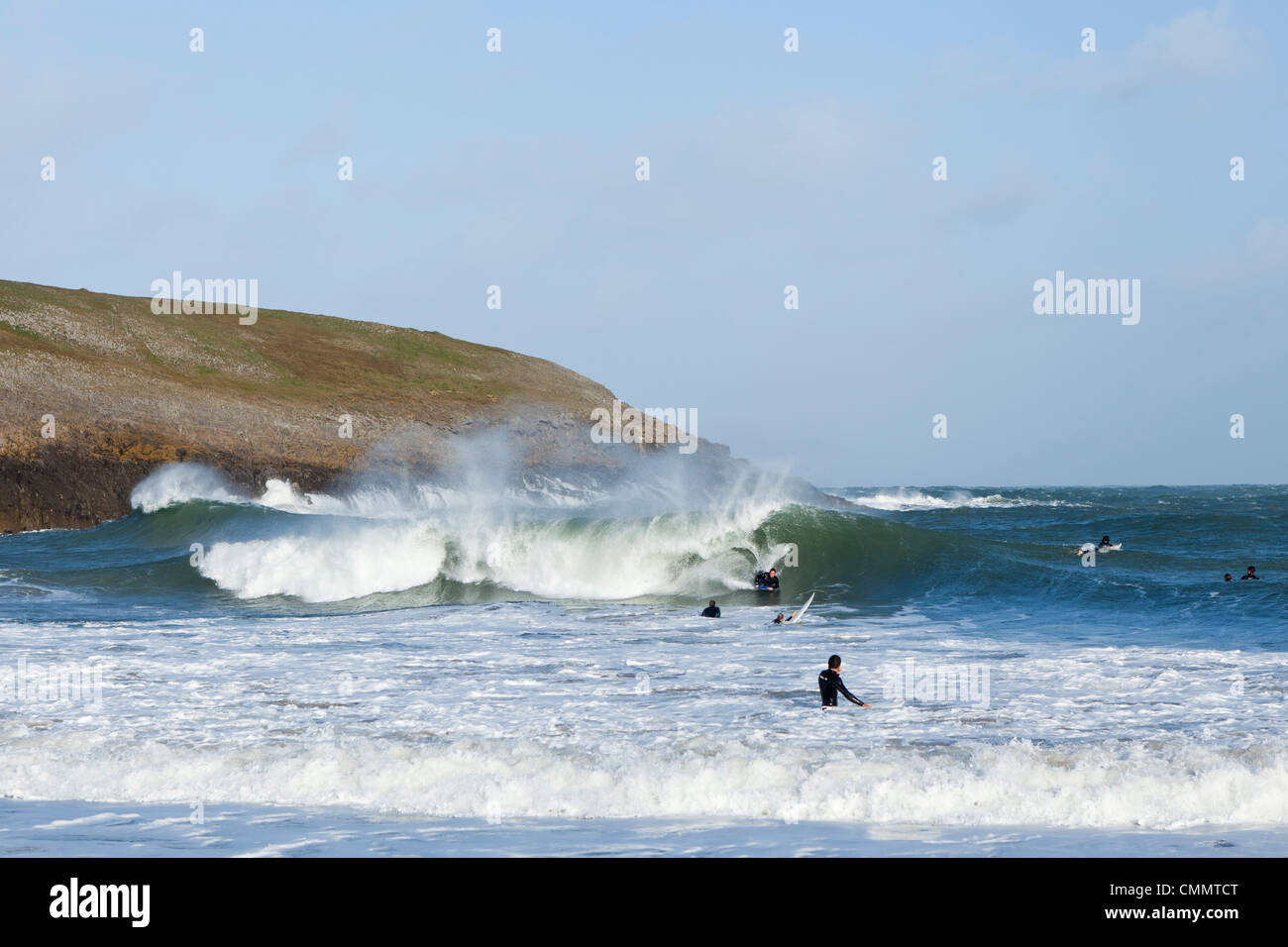 Surfers practice in the sea at Broadhaven Beach, West Wales. Stock Photo