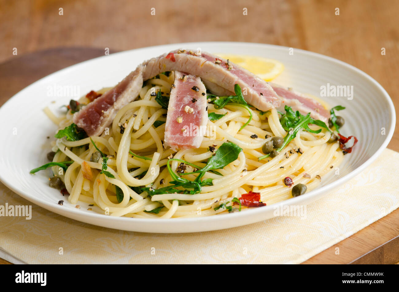 Spaghetti with tuna steak, rocket and herbs Stock Photo - Alamy