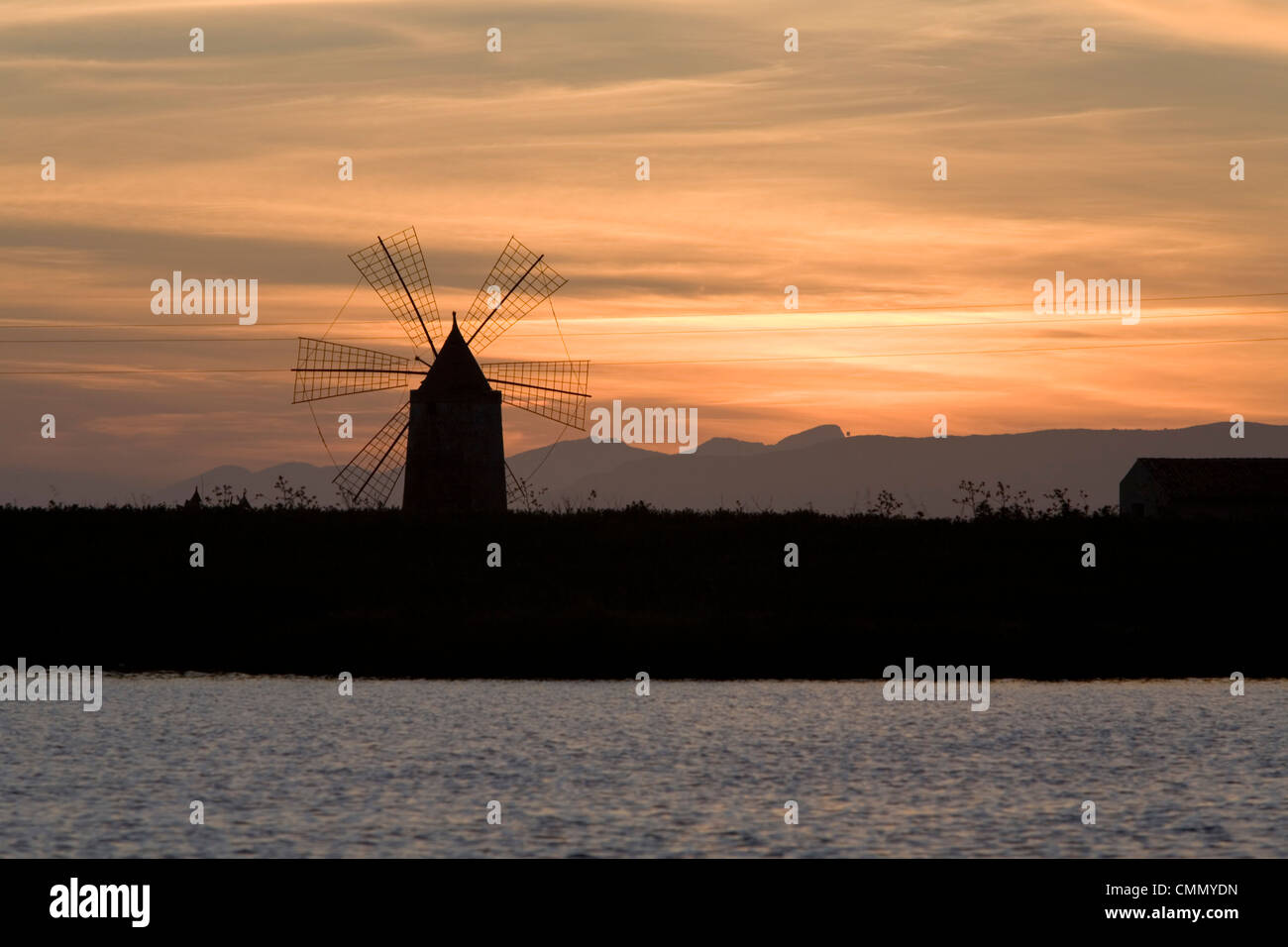 Sunset over windmill on salt beds, Trapani, Sicily, Italy, Mediterranean, Europe Stock Photo