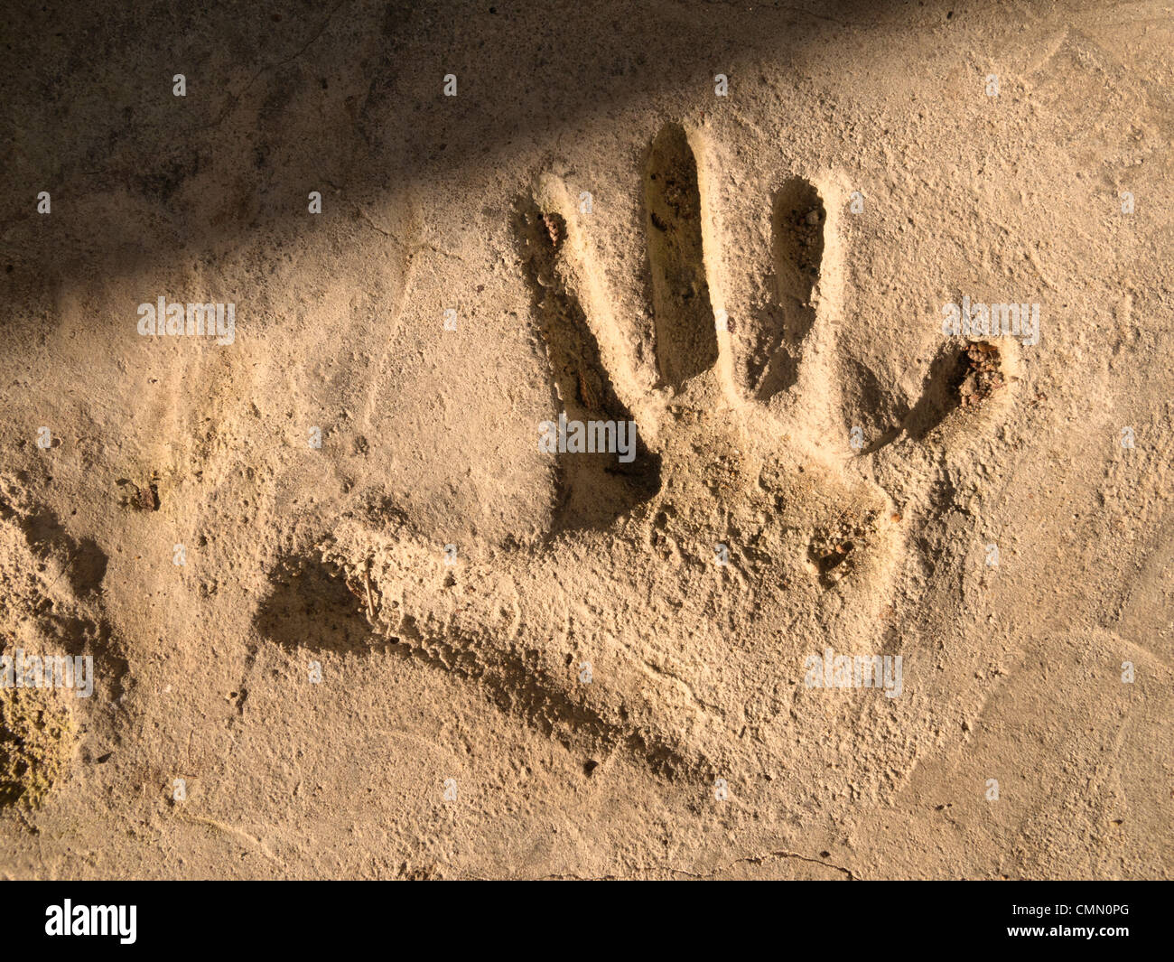 Imprint of child's hand in cement Stock Photo