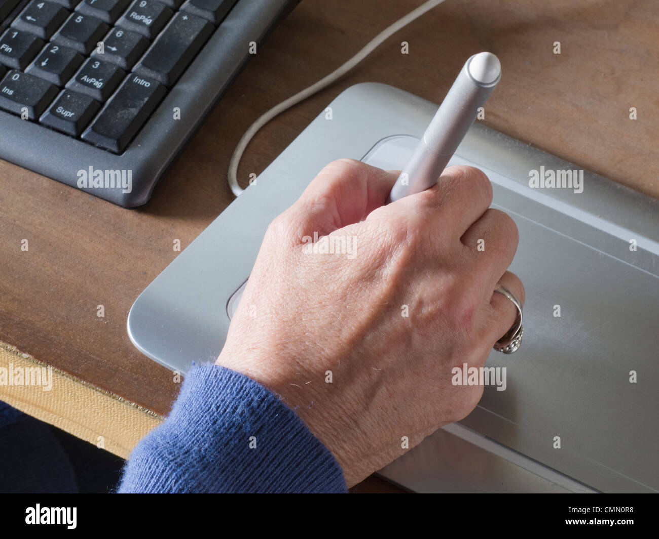 Graphic designer using tablet and pen Stock Photo