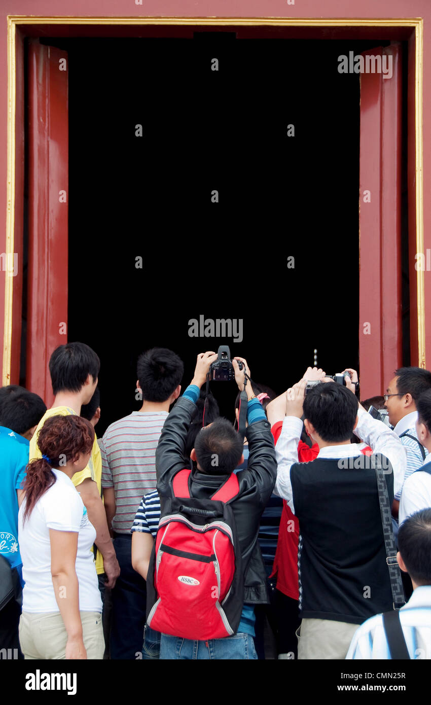 A crowd of tourists taking photographs within the Forbidden City, Beijing, China. Stock Photo