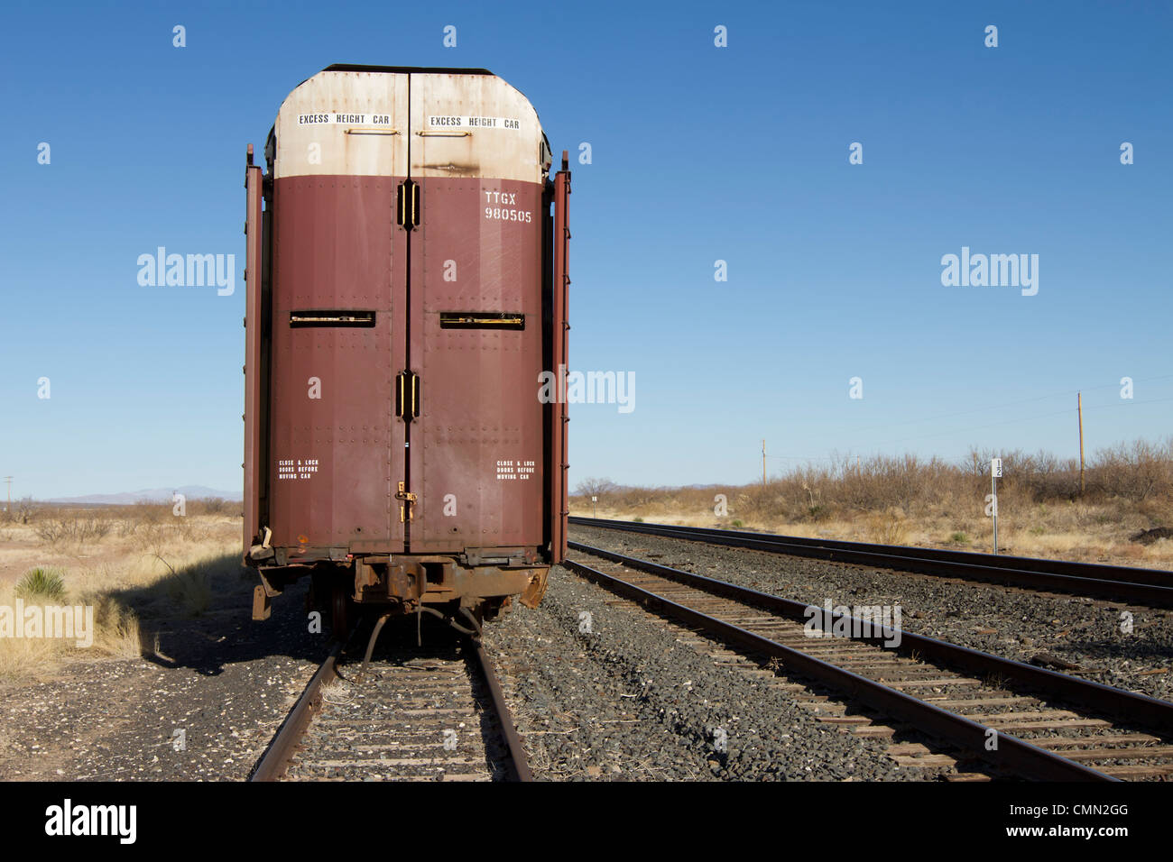 Railroad car designed to transport automobiles parked in rural west Texas. Stock Photo