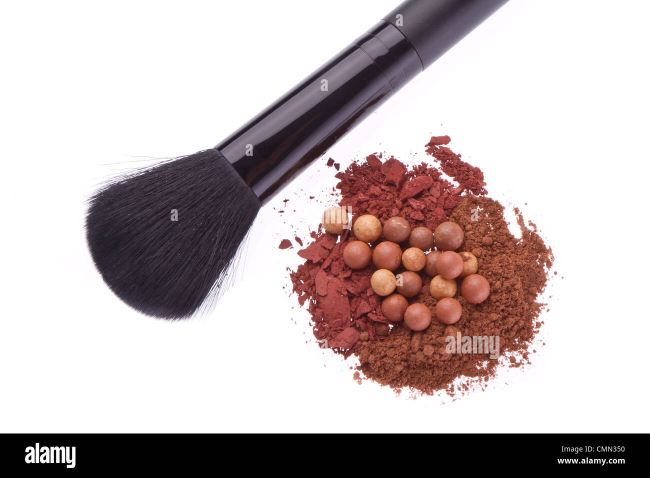 bronzing pearls and crushed eyeshadows with brush isolated on white