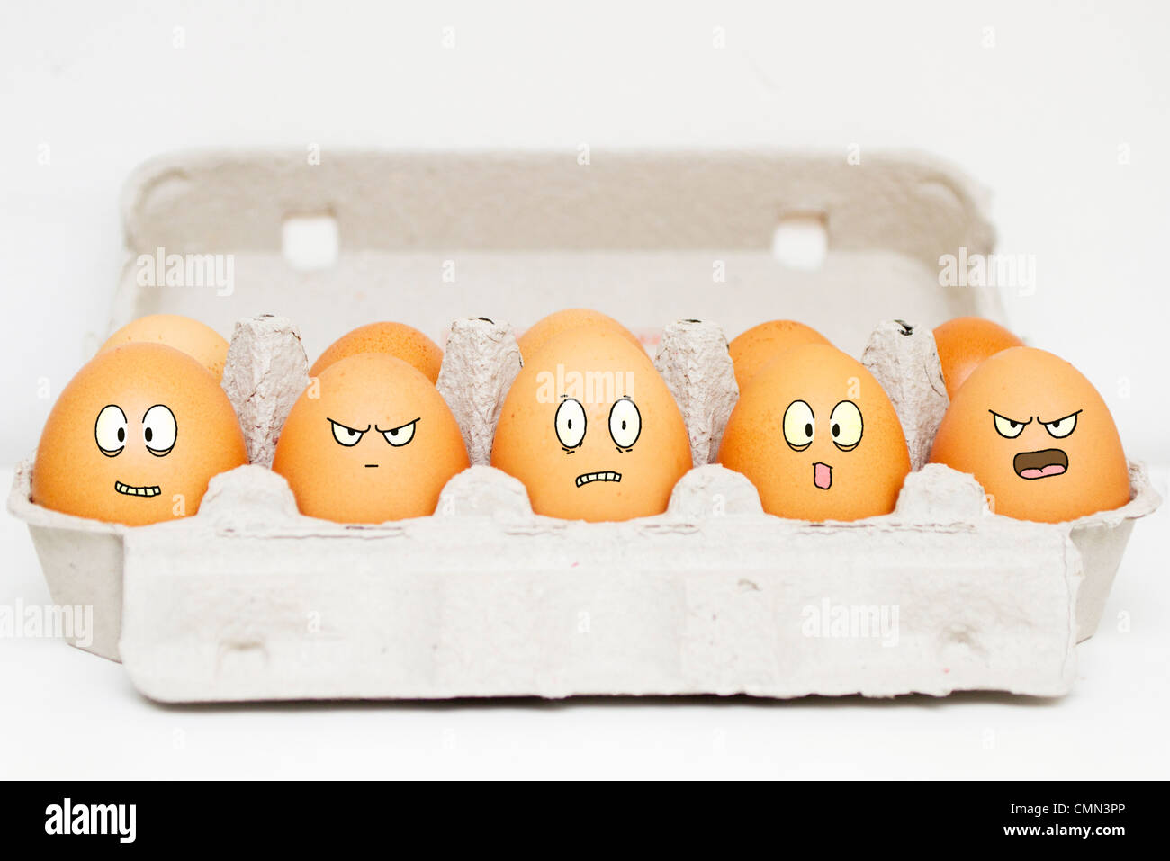 Happy, angry, scared and sad eggs in their box Stock Photo