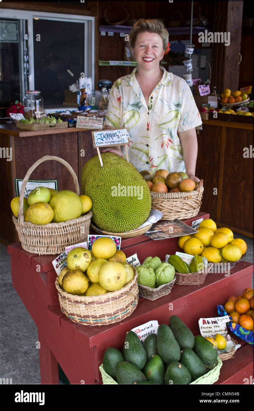 USA, Hawaii, S. Kona. Woman sells local organic fruit at S. Kona Fruit