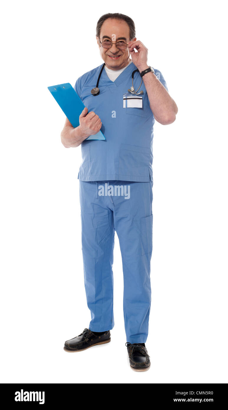 Medical professional looking at camera while holding his eyeglasses Stock Photo
