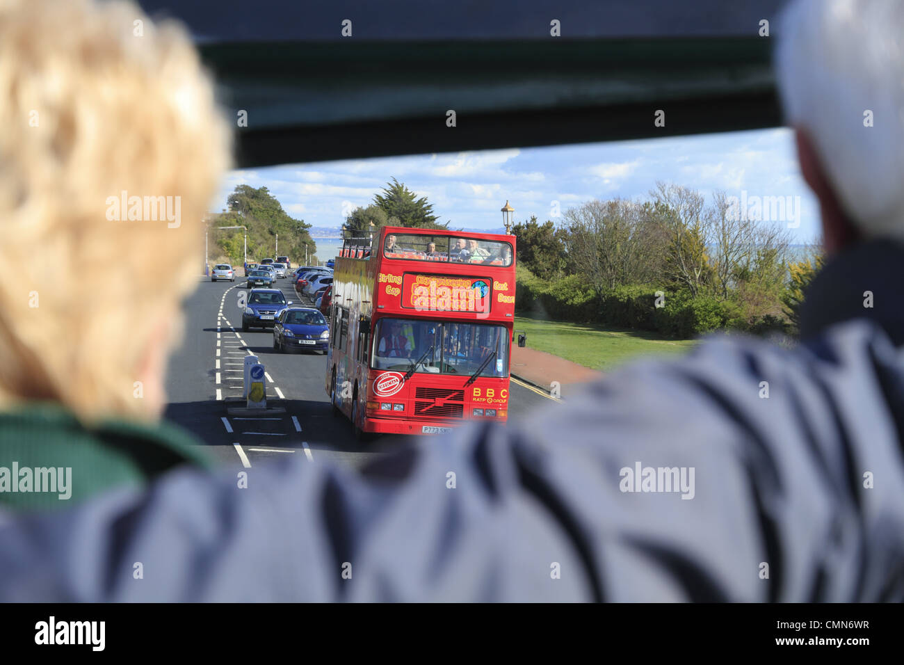 Tourists on an open top bus tour at Eastbourne, East Sussex, England. Stock Photo