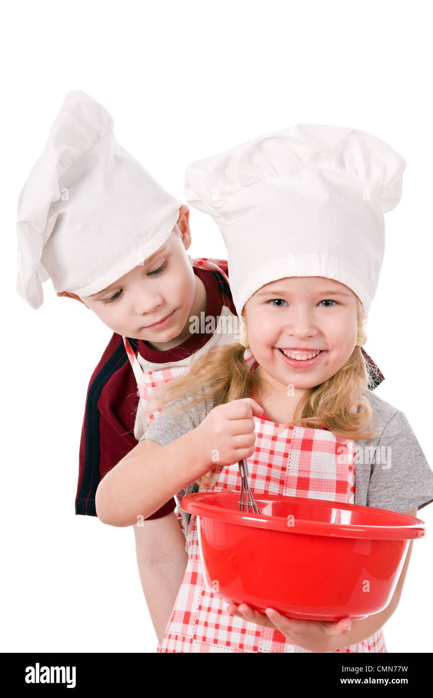 two children in chef's hat isolated on white background Stock Photo