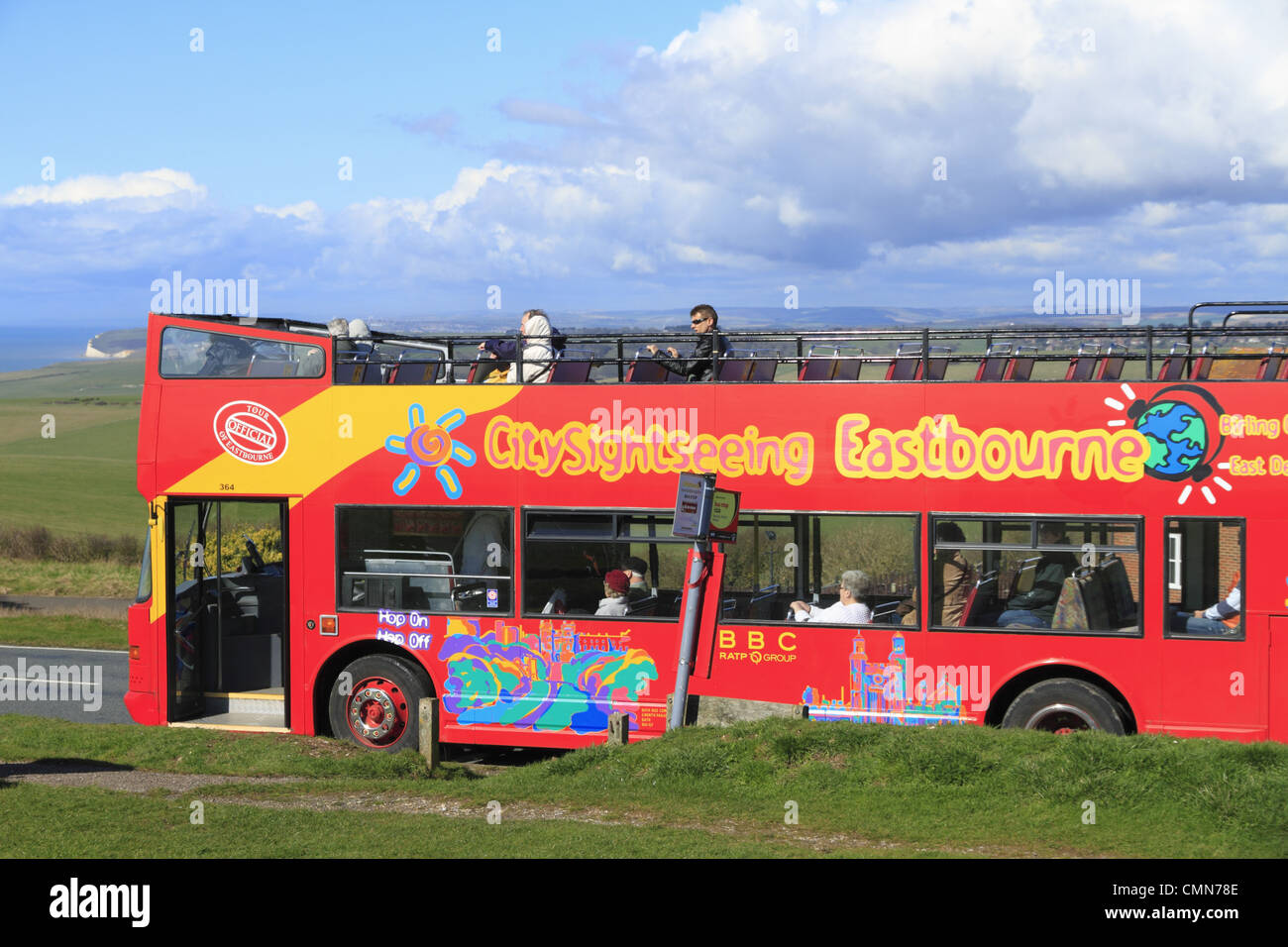 An open top bus tour calls at Beachy Head on the South Downs National Park near Eastbourne, East Sussex, England. Stock Photo