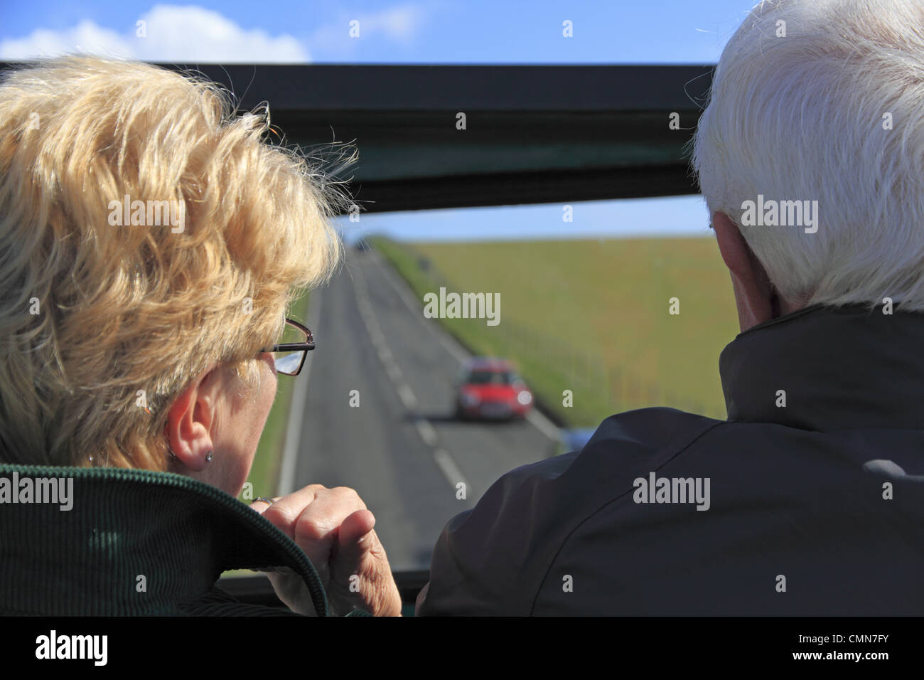 Tourists on an open top bus tour at Beachy Head on the South Downs National Park near Eastbourne, East Sussex, England. Stock Photo
