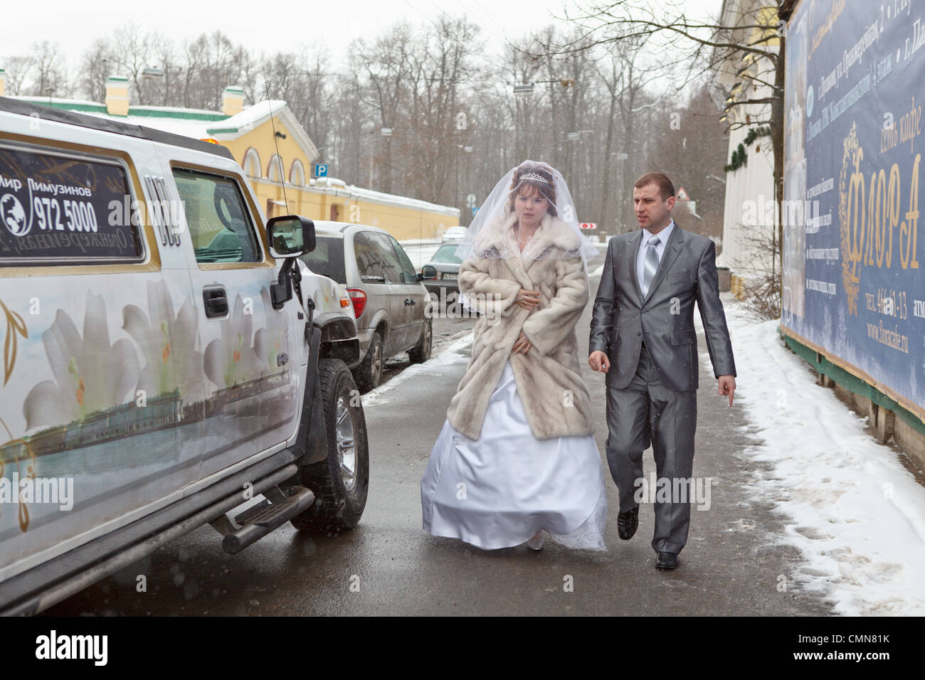 Bride and groom standing near car limousine in winter season Stock ...
