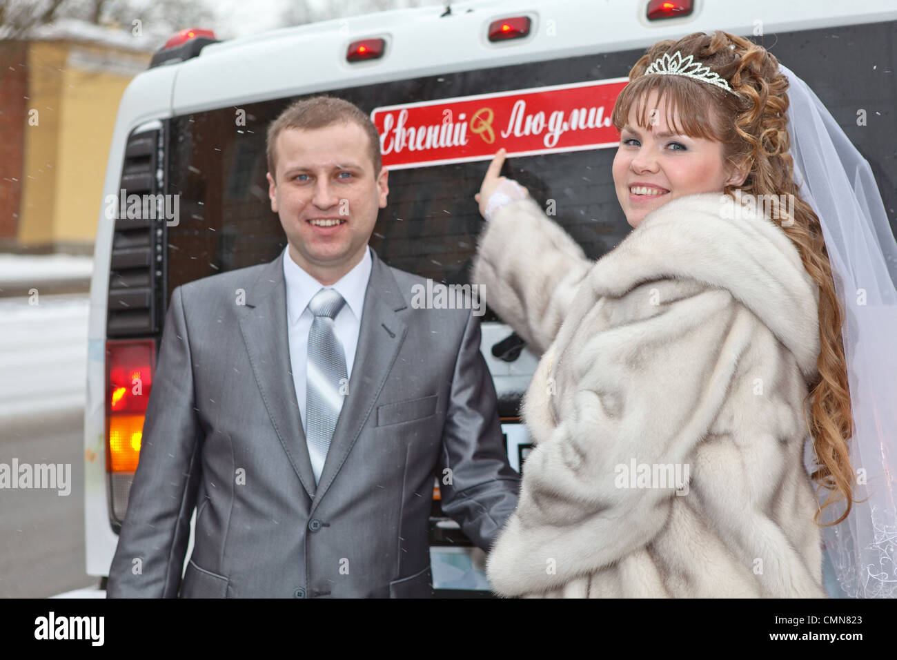 Bride and groom standing near car limousine in winter season Stock ...