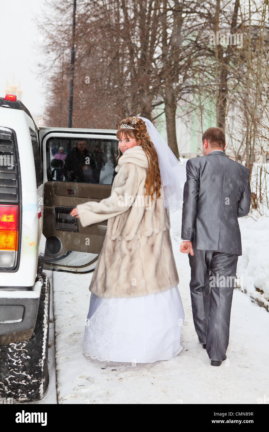 Bride and groom standing near car limousine in winter season Stock ...