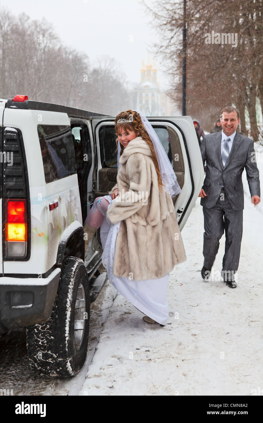 Bride and groom standing near car limousine in winter season Stock ...