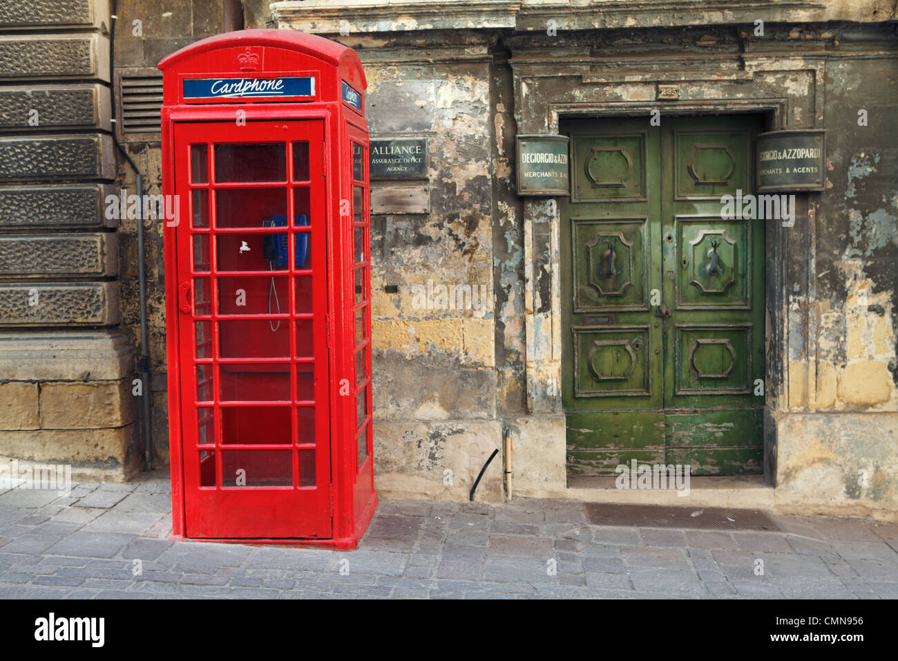 Red British Photnebox and Old Doorway in the Capital Valletta, Malta Stock Photo
