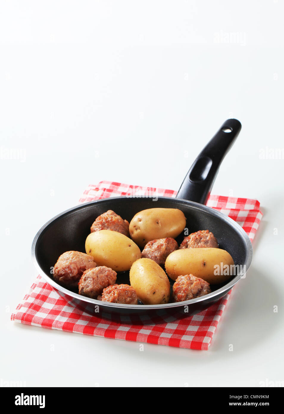 Panfried meatballs and potatoes in a fry pan Stock Photo Alamy