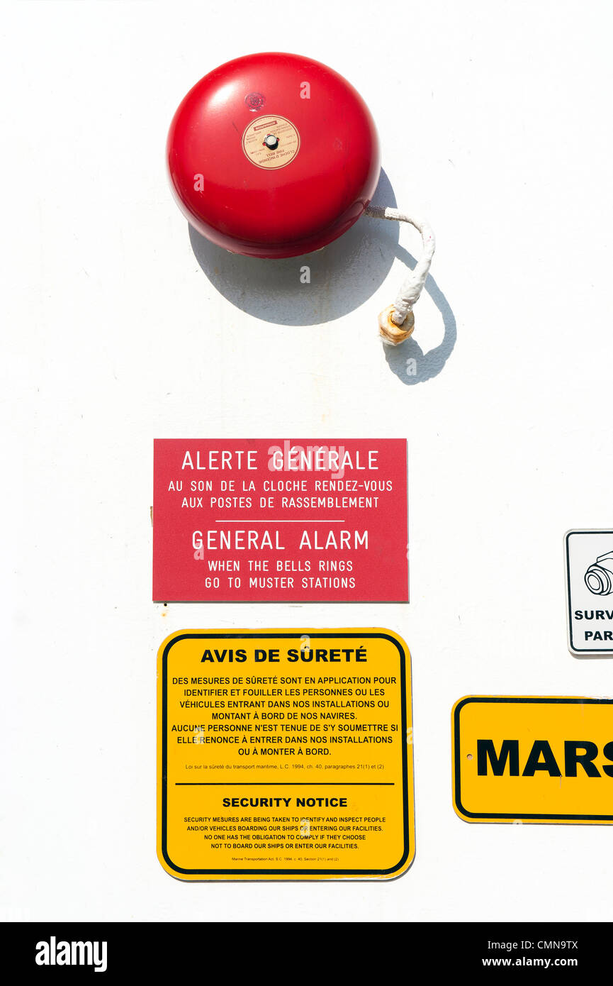 Alarm bell and bilingual security notice on a ferry boat in Canada. Stock Photo