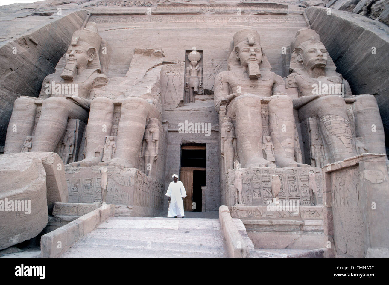Four colossal statues of Ramesses II guard the entrance to his famous rock-cut temple at Abu Simbel built in Nubia, Egypt, to honor himself as pharaoh. Stock Photo