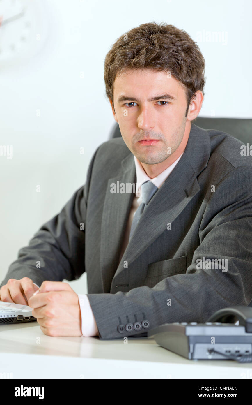 Angry modern business man banging fist on table Stock Photo