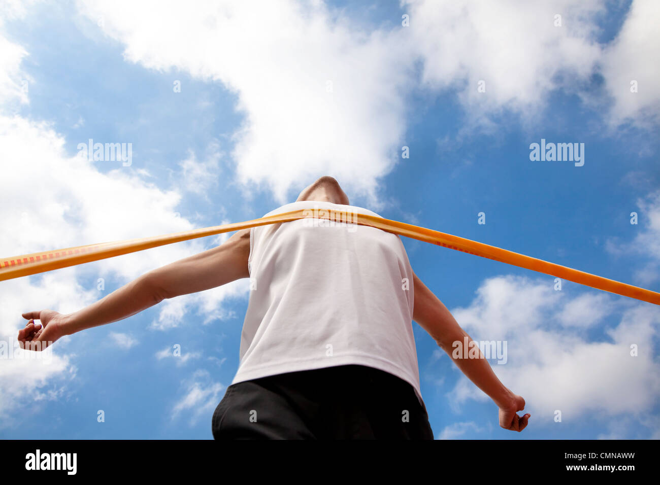 Winning runner with cloud background Stock Photo