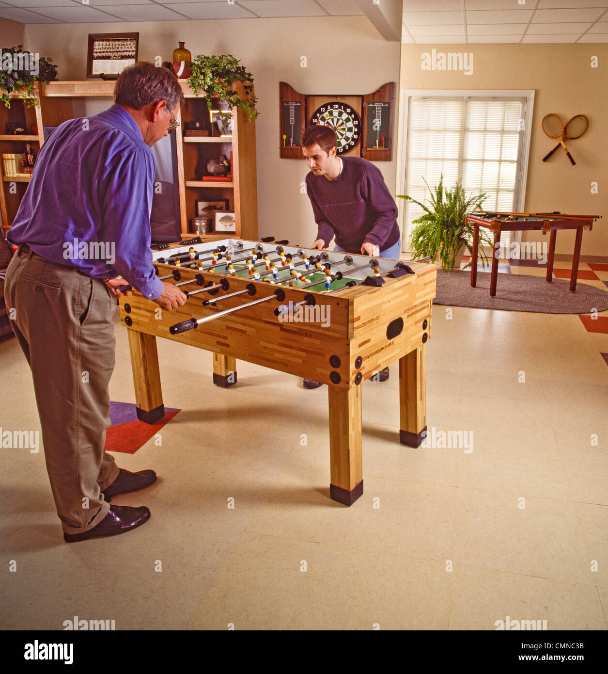 Family playroom foosball table top game competition Stock Photo Alamy