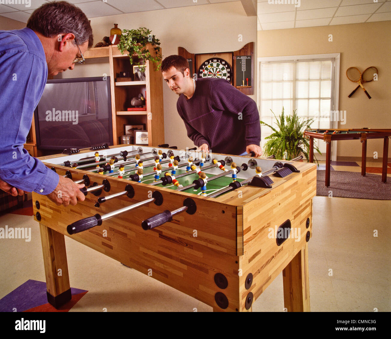 Family playroom foosball table top game competition Stock Photo Alamy
