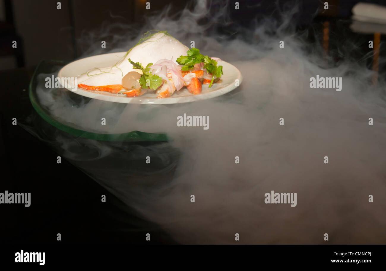 molecular gastronomy, red curry served above liquid nitrogen in Bangkok, Thailand Stock Photo