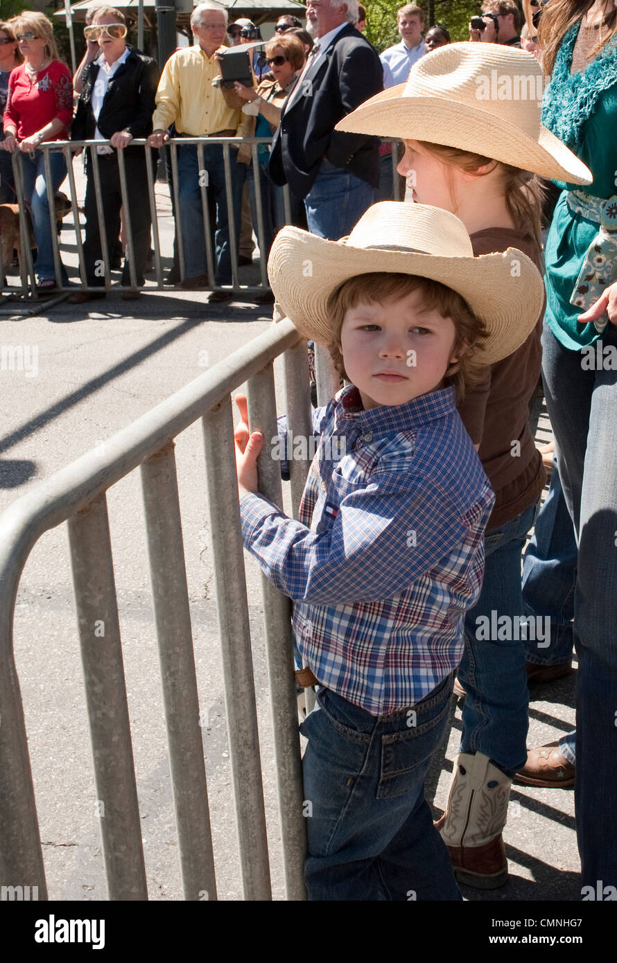 Young boy and young girl wearing cowboy hats at outdoor Texas Rodeo event Stock Photo