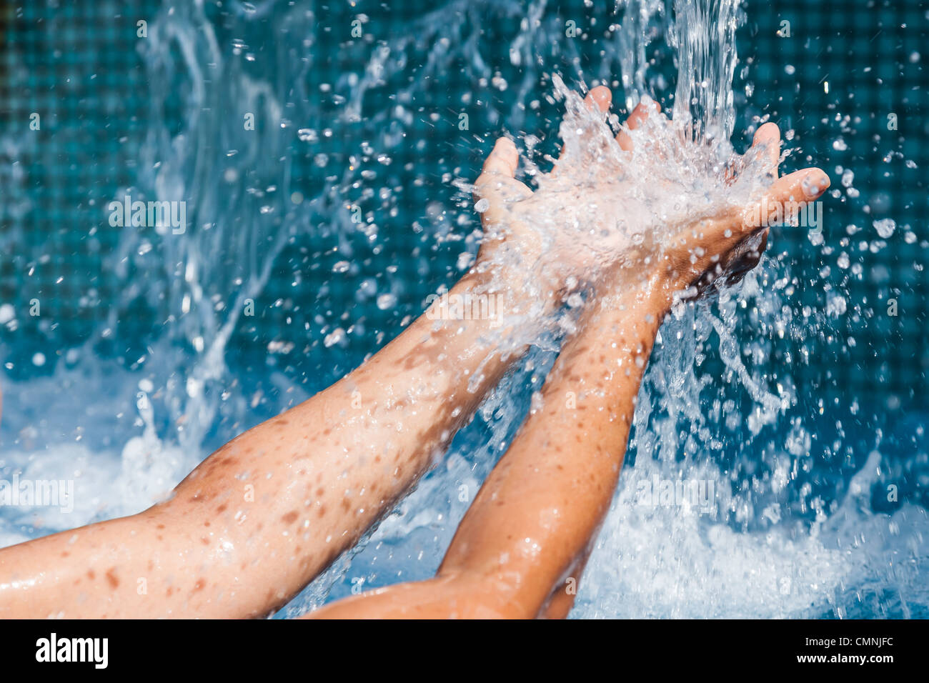 Water pouring into the hands of a woman Stock Photo Alamy