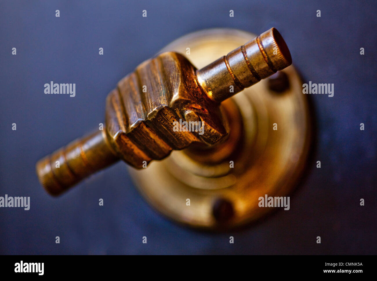 Safe door handle using a brass fist holding a metal scroll. Stock Photo