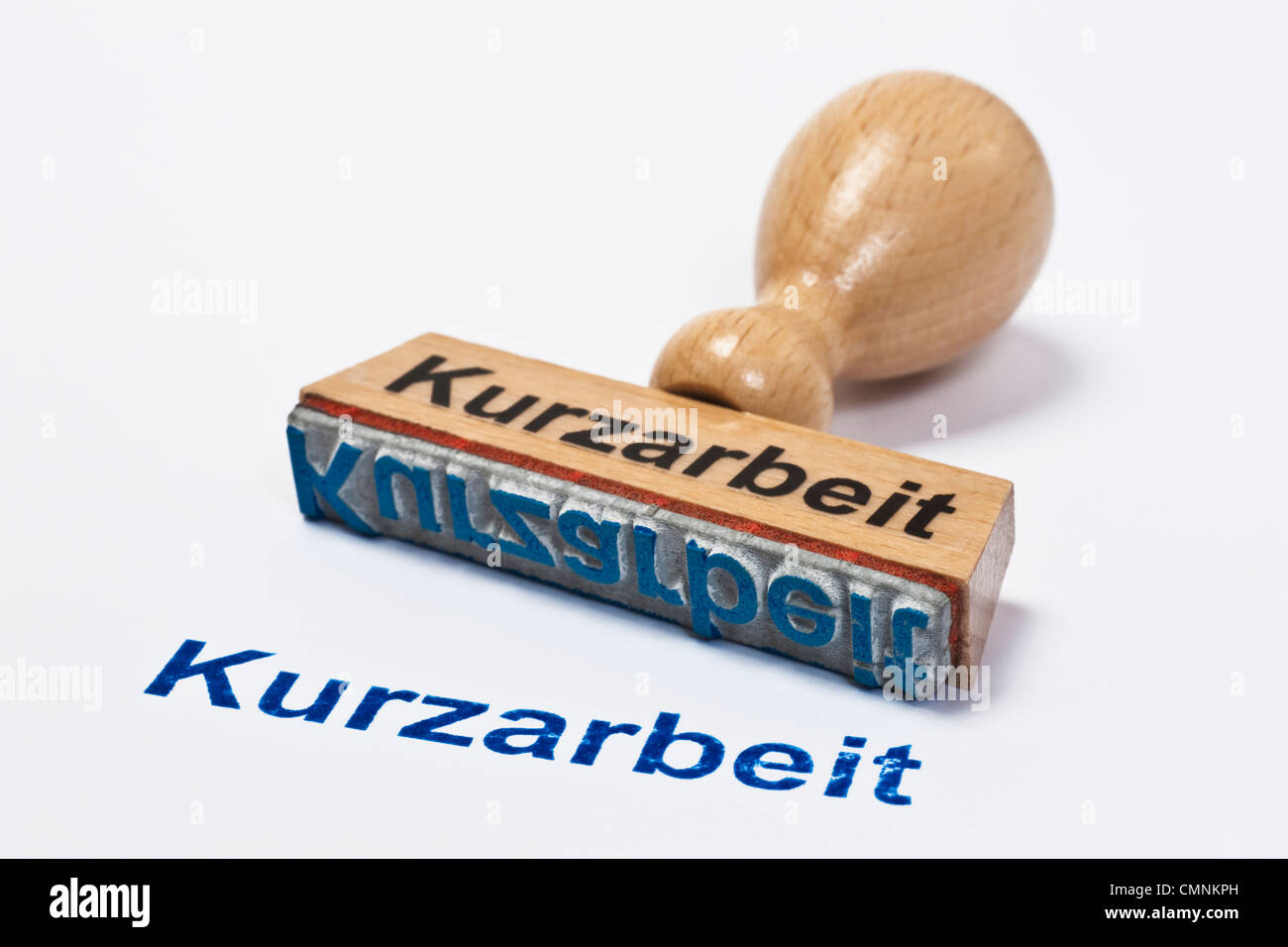 Detailansicht eines Stempels mit der Aufschrift Kurzarbeit | Detail photo of a stamp with inscription in German short-time work Stock Photo