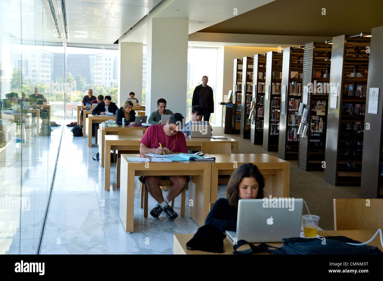 People working and studying in a library Stock Photo - Alamy